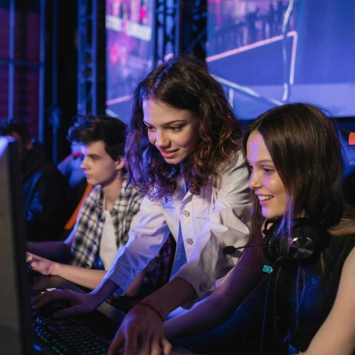 Two enthusiastic young women enjoying a gaming session at an esports event.